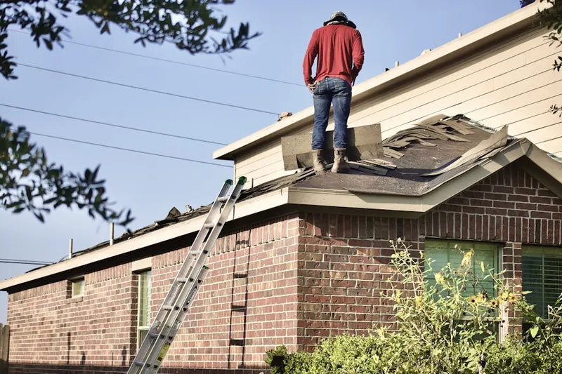 Professional roofer working on a residential roof in Avalon Heights